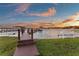 Waterfront property featuring private wooden dock extending to beautiful lake, perfect for boating, swimming and enjoying scenic views at 2844 Marquesas Ct, Windermere, FL 34786