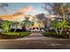 Luxurious estate with circle driveway, custom stone wall, mature trees, and manicured lawn at 2844 Marquesas Ct, Windermere, FL 34786