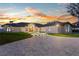 Estate with a curved paver driveway, arched windows, and illuminated landscaping at 2844 Marquesas Ct, Windermere, FL 34786