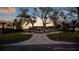 Stately home with a circular driveway framed by mature trees and lush landscaping at 2844 Marquesas Ct, Windermere, FL 34786
