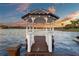 Charming gazebo at end of wooden pier offers stunning views and a peaceful waterfront retreat on this lakefront property at 2844 Marquesas Ct, Windermere, FL 34786