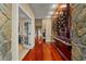 Grand hallway with wood floors, stone accents, and a custom wine display for an elegant and inviting entrance at 2844 Marquesas Ct, Windermere, FL 34786