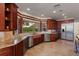 Well-appointed kitchen with custom cabinets, stainless steel appliances, and natural stone countertops at 2844 Marquesas Ct, Windermere, FL 34786