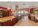 Gourmet kitchen featuring granite countertops, stainless appliances, and breakfast bar overlooking the lake at 2844 Marquesas Ct, Windermere, FL 34786