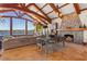 Cozy living space with a stone fireplace, water views, and comfortable seating and dining areas at 2844 Marquesas Ct, Windermere, FL 34786