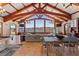Expansive living area with beamed ceilings, tile floors, and lake views at 2844 Marquesas Ct, Windermere, FL 34786