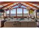 Open living space with expansive windows overlooking a waterfront view, vaulted ceiling, and modern furniture at 2844 Marquesas Ct, Windermere, FL 34786