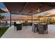 Outdoor kitchen with bar seating, ceiling fans and sunset views over the lake at 2844 Marquesas Ct, Windermere, FL 34786