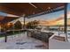 Stunning outdoor kitchen and bar area with stainless steel appliances overlooking the water at sunset at 2844 Marquesas Ct, Windermere, FL 34786