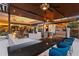 Spacious outdoor kitchen and bar area with seating and ceiling fans for entertaining at 2844 Marquesas Ct, Windermere, FL 34786