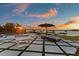 Lounge seating and ping pong table on the patio offer beautiful waterfront views at sunset at 2844 Marquesas Ct, Windermere, FL 34786