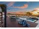Beautiful pool area with spa, lounge seating, and outdoor shower overlooking the water at sunset at 2844 Marquesas Ct, Windermere, FL 34786