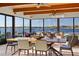 Spacious sunroom dining area with waterfront views and comfortable seating at 2844 Marquesas Ct, Windermere, FL 34786