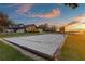 Volleyball court on lakefront property surrounded by lush landscaping and clear skies at 2844 Marquesas Ct, Windermere, FL 34786