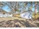 Backyard featuring a shed, partial fence, and mature trees for shade at 3434 Se 12Th St, Ocala, FL 34471