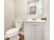 Cozy half bathroom featuring a toilet and a vanity with a modern sink and mirror at 3434 Se 12Th St, Ocala, FL 34471