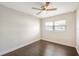 Bedroom featuring hardwood floors, a ceiling fan, and natural light from two windows at 3434 Se 12Th St, Ocala, FL 34471