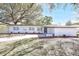 Charming single-story home with freshly painted white exterior and beautiful landscaping at 3434 Se 12Th St, Ocala, FL 34471