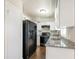 Modern kitchen features sleek black appliances, granite countertops, and ample white cabinet space for storage at 3434 Se 12Th St, Ocala, FL 34471