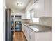 Modern kitchen offers granite countertops, black appliances, and abundant cabinetry for storage and food preparation at 3434 Se 12Th St, Ocala, FL 34471