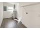 Utility room featuring hard wood floors, a water heater, and wire shelving at 3434 Se 12Th St, Ocala, FL 34471