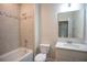 Bathroom displays tub/shower combo, white tile, and vanity at 355 S Sunset Ave, Mascotte, FL 34753