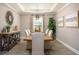 Elegant dining room featuring tray ceilings, a modern light fixture, and neutral decor at 355 S Sunset Ave, Mascotte, FL 34753