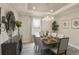 Beautiful dining room with tray ceilings, modern lighting, and ample natural light at 355 S Sunset Ave, Mascotte, FL 34753
