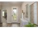 Entryway features decorative glass door and stylish console table at 355 S Sunset Ave, Mascotte, FL 34753
