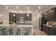 Modern kitchen featuring stainless steel appliances, a granite countertop island, and stylish cabinetry at 355 S Sunset Ave, Mascotte, FL 34753