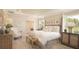 Relaxing main bedroom with natural light, stylish decor, and a view of the outdoors at 355 S Sunset Ave, Mascotte, FL 34753