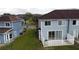 View of a backyard with a white fence and sliding doors leading to the townhouse at 373 Caribbean Dr, Davenport, FL 33897
