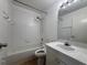 Clean bathroom with shower-tub combo, tiled walls, and vanity at 373 Caribbean Dr, Davenport, FL 33897