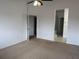 Open-concept bedroom featuring neutral carpet, access to bathroom, and bright lighting at 373 Caribbean Dr, Davenport, FL 33897
