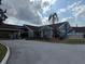 Exterior of a community clubhouse with well-maintained landscaping at 373 Caribbean Dr, Davenport, FL 33897
