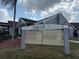 Community clubhouse sign listing amenities such as the pool, fitness center, and tennis court at 373 Caribbean Dr, Davenport, FL 33897