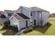 Charming two-story townhouse with brown roof, light blue siding, and a well-maintained lawn at 373 Caribbean Dr, Davenport, FL 33897