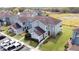 Aerial view of a complex of two-story townhouses with well-manicured lawns and parking at 373 Caribbean Dr, Davenport, FL 33897