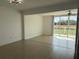 Bright, open-concept living room with tile floors and a sliding door to the patio at 373 Caribbean Dr, Davenport, FL 33897