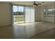 Bright living room featuring tile flooring, ceiling fan, and sliding door access to the outdoor patio at 373 Caribbean Dr, Davenport, FL 33897