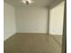 Large, empty living room with neutral tile flooring and modern lighting fixtures at 373 Caribbean Dr, Davenport, FL 33897