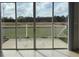 Sliding glass doors leading to a white fenced patio overlooking a serene outdoor area at 373 Caribbean Dr, Davenport, FL 33897