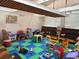Community playroom with toys, seating, and playmat flooring at 373 Caribbean Dr, Davenport, FL 33897