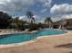 A sparkling swimming pool with lounge chairs surrounded by lush landscaping at 373 Caribbean Dr, Davenport, FL 33897
