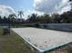 Community beach volleyball court with benches, trees, and a perimeter fence at 373 Caribbean Dr, Davenport, FL 33897