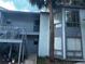 Two-story condominium building with exterior stairs and a mature palm tree at 4358 Aqua Vista Dr # G, Orlando, FL 32839
