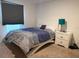 Comfortable bedroom featuring a window, bedside table, and neutral tones at 439 Mulberry Ct, Kissimmee, FL 34759
