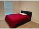 Cozy bedroom with plush carpet, a double bed and a large window at 439 Mulberry Ct, Kissimmee, FL 34759