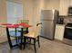 Eat-in kitchen with stainless steel appliances and a modern glass top table at 439 Mulberry Ct, Kissimmee, FL 34759