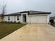 Charming single-story home featuring a two-car garage and well-maintained landscaping at 439 Mulberry Ct, Kissimmee, FL 34759